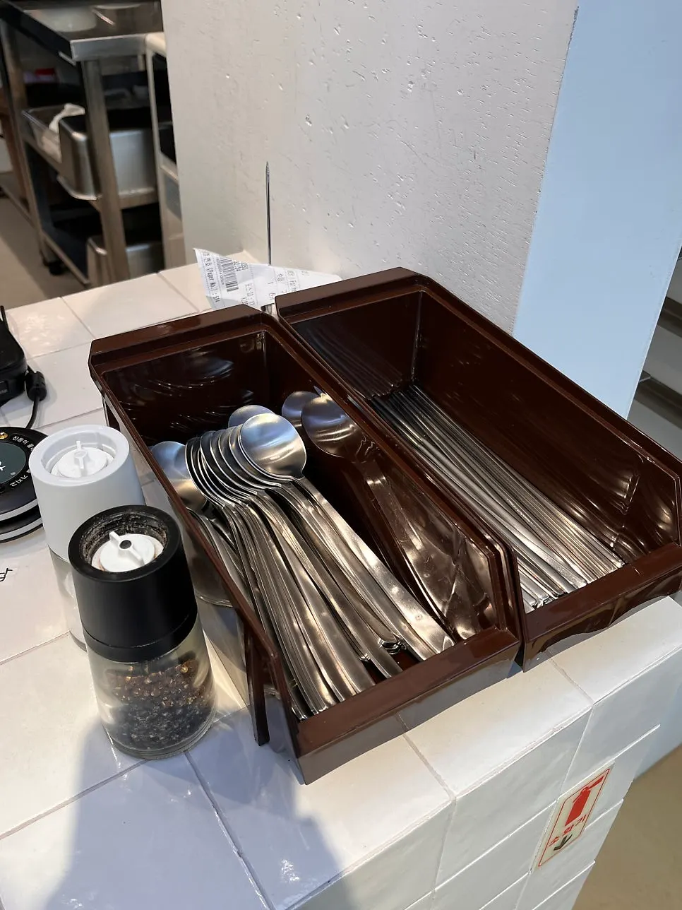 Self-serve corner with dishes, water, and tissues