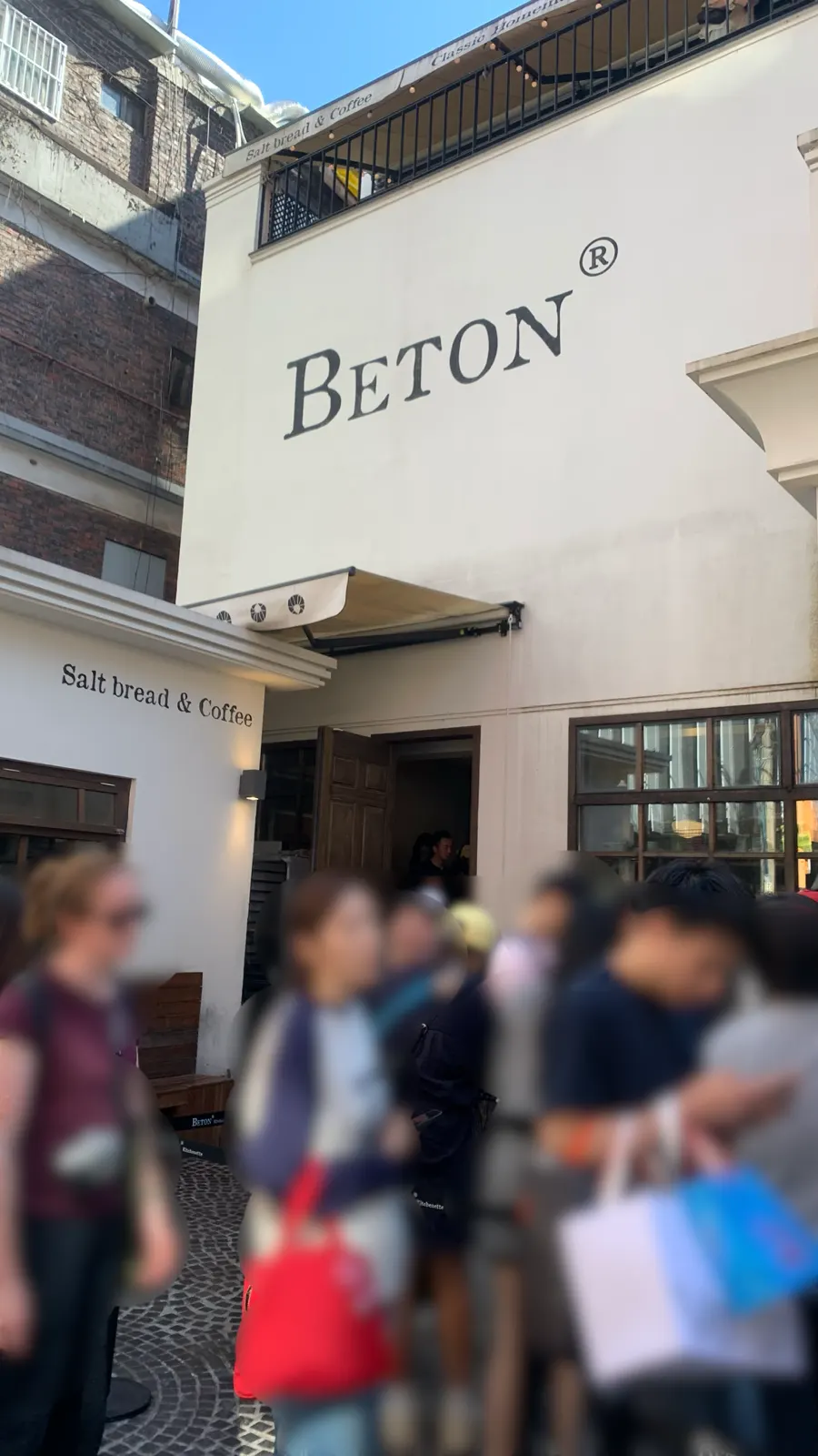 A line of customers waiting outside the salt bread bakery next to Gyuen Dang