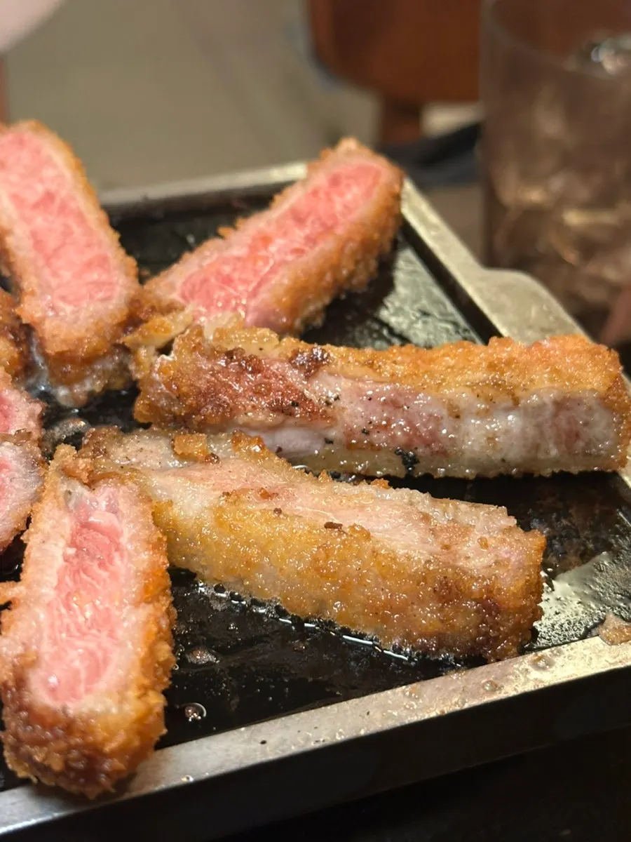 Beef katsu grilling in butter over the brazier