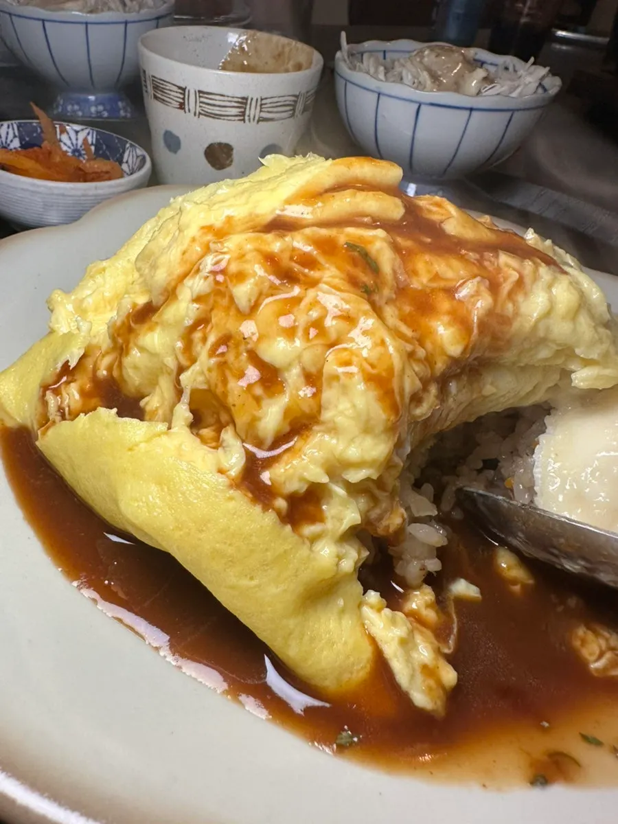 A full omurice meal with cheese and sauce