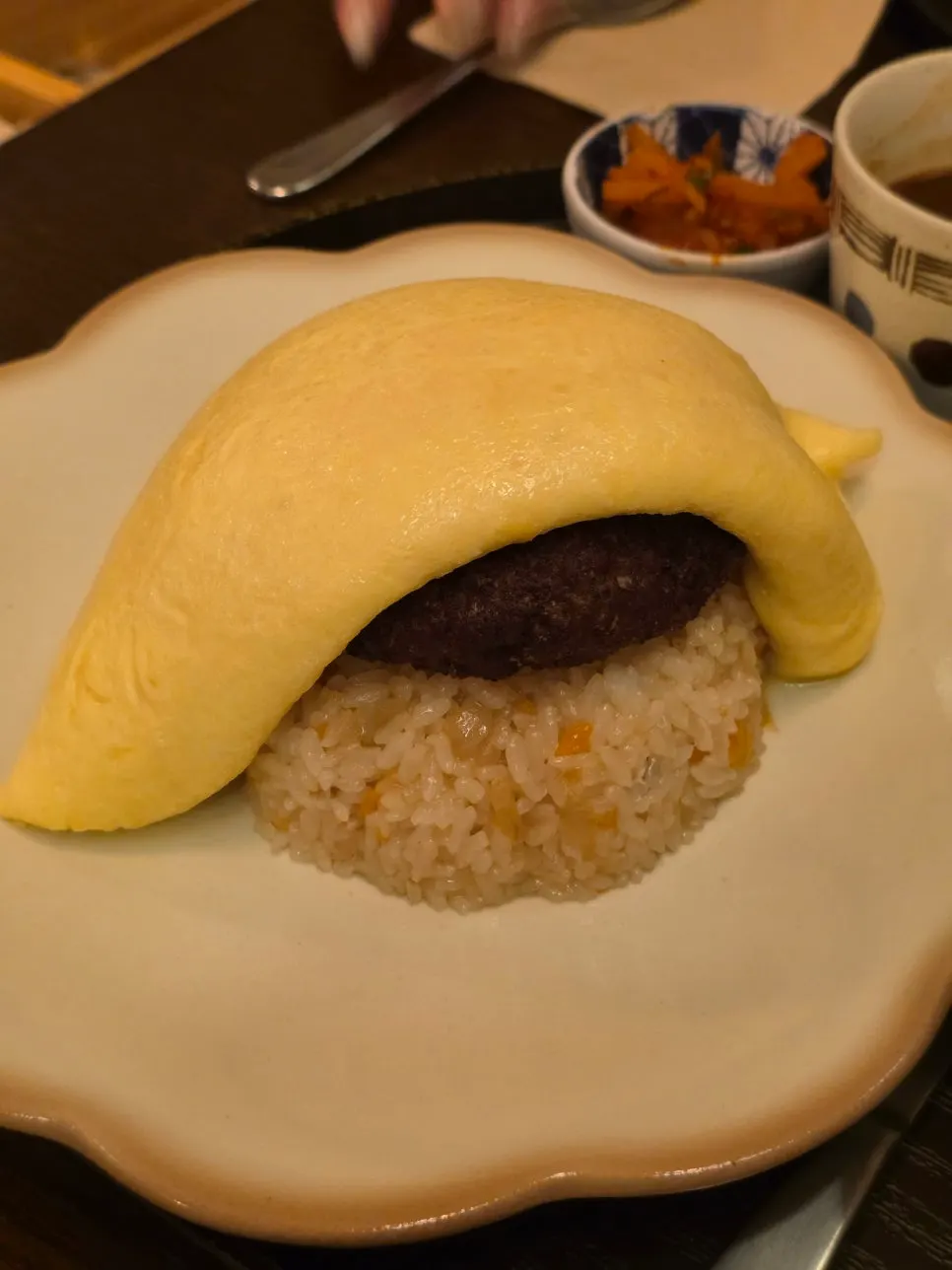 Cutting into the omurice's egg with a knife
