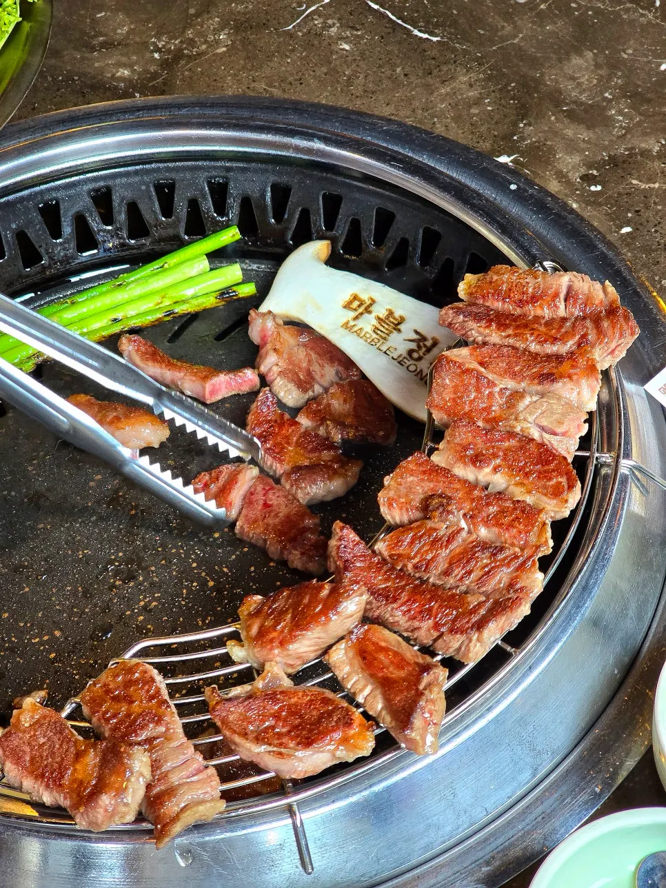 Beef sirloin cooking on the downdraft ventilation grill