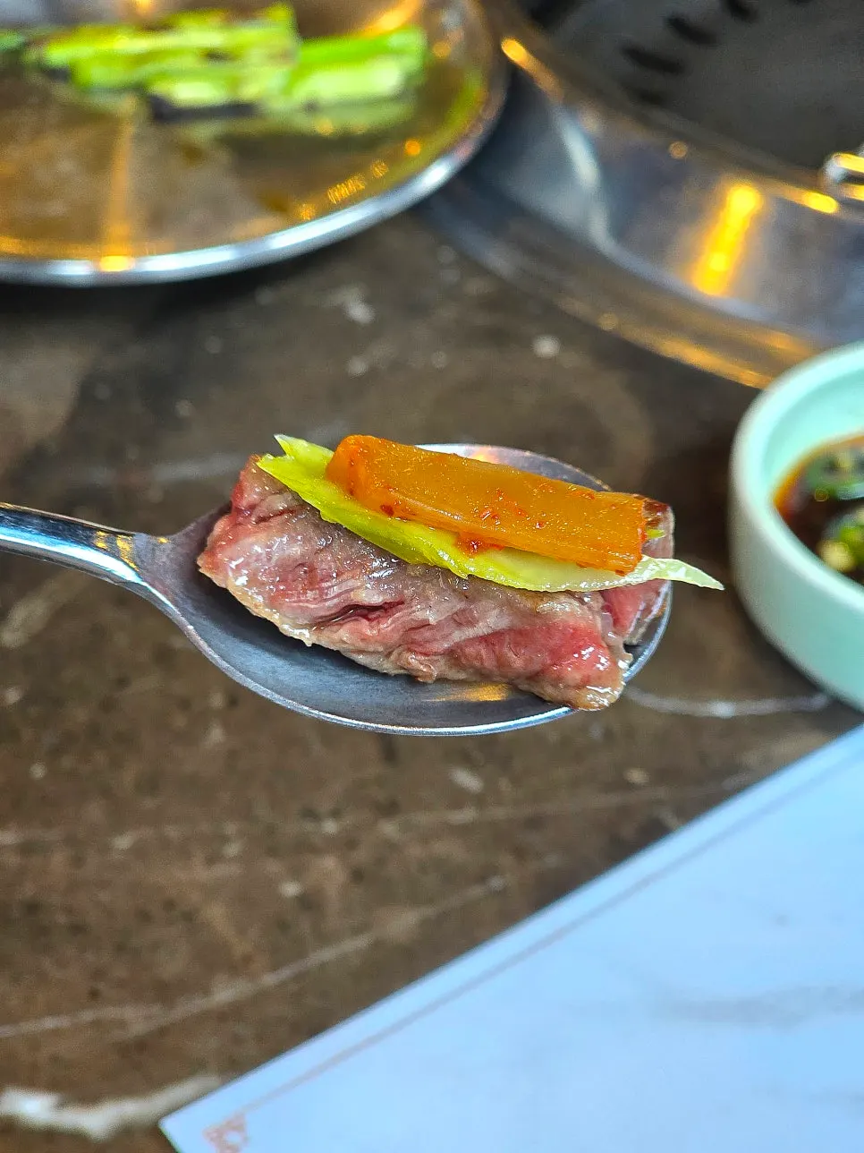 Grilled beef piece dipped in pairing sauce