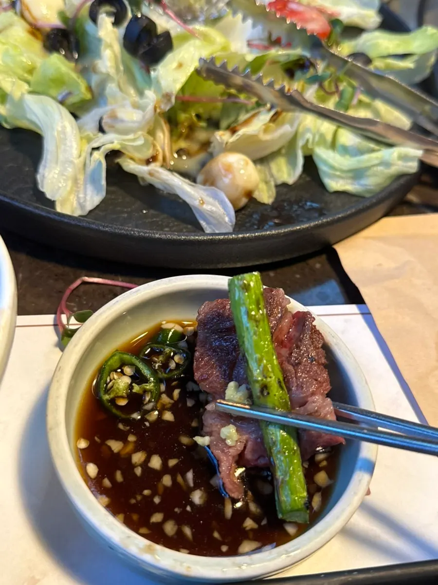 Brisket point served with wild garlic leaves and pickled radish