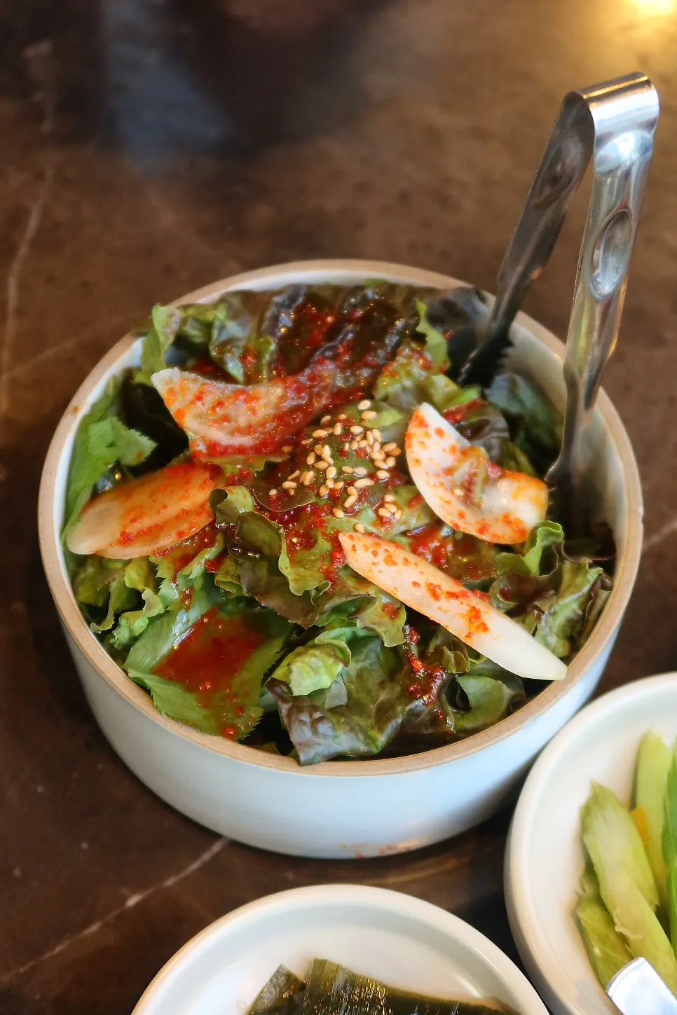 Salad and seasoned lettuce side dishes at Marblejeong