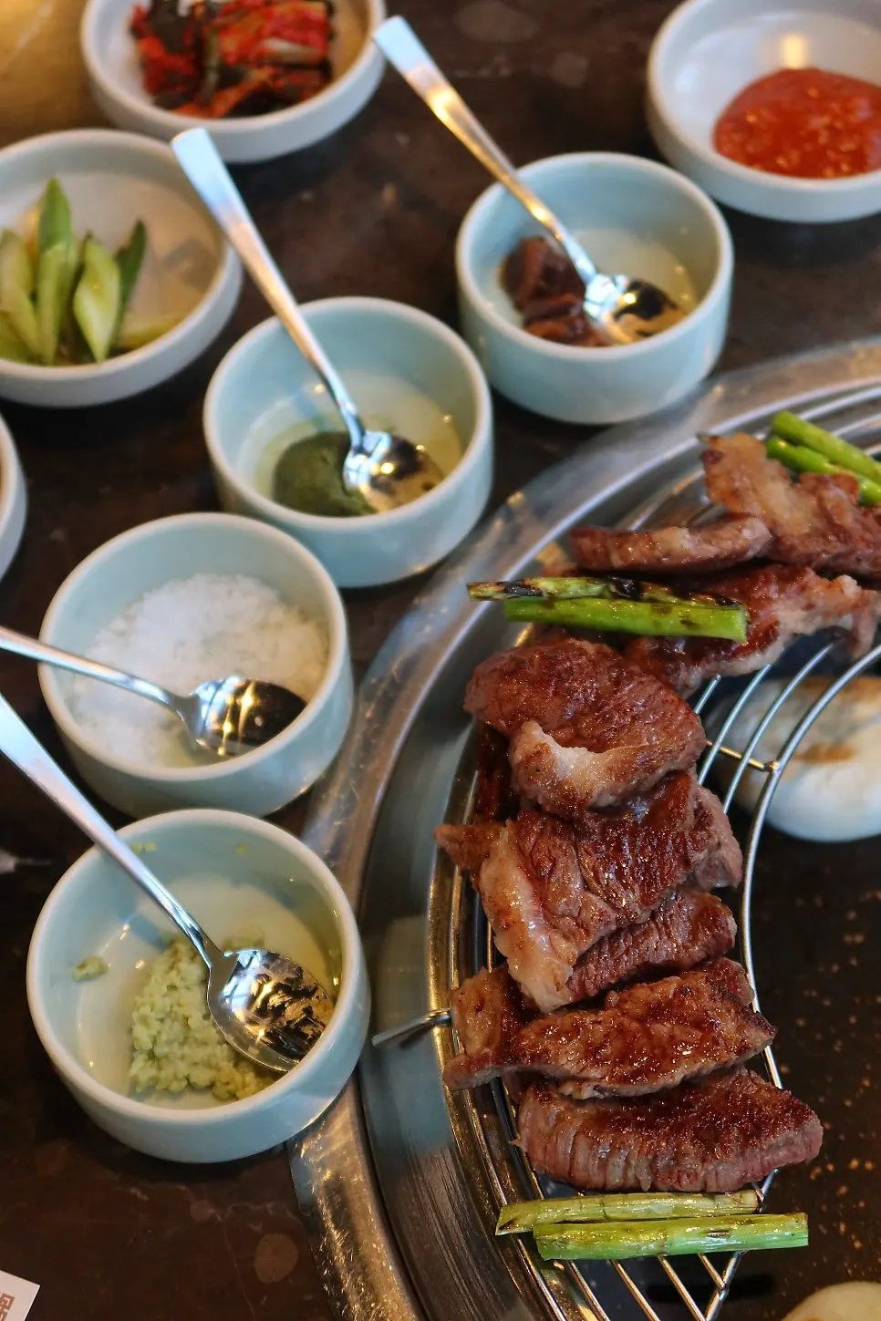 Staff grilling Marblejeong's premium Korean beef mixed grill