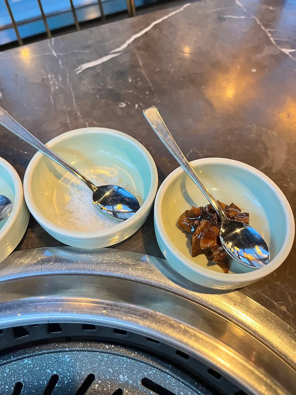 Table with side dishes and sauces at Marblejeong