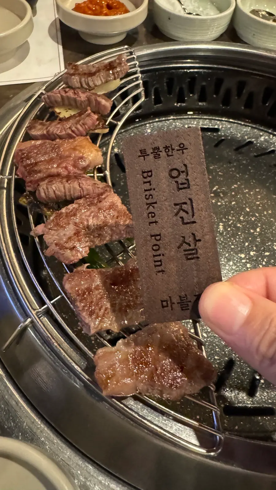 Chopsticks picking up a piece of beef flank