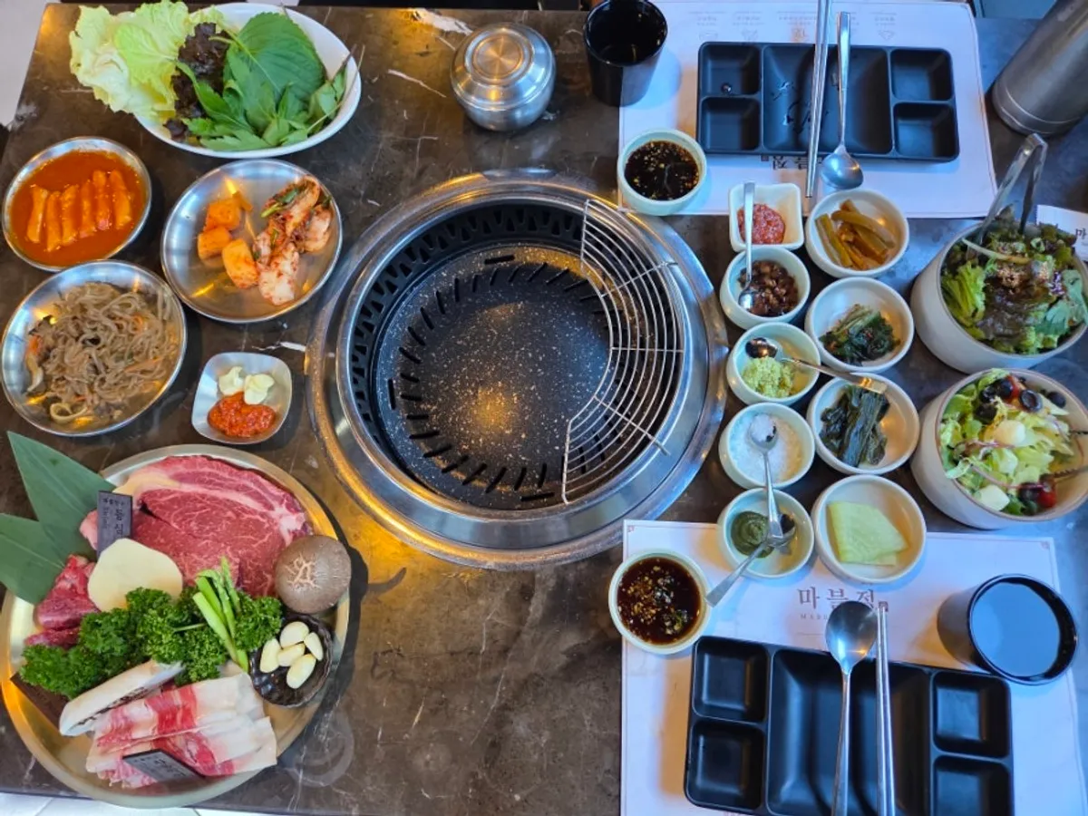 Full table spread with the mixed grill and side dishes