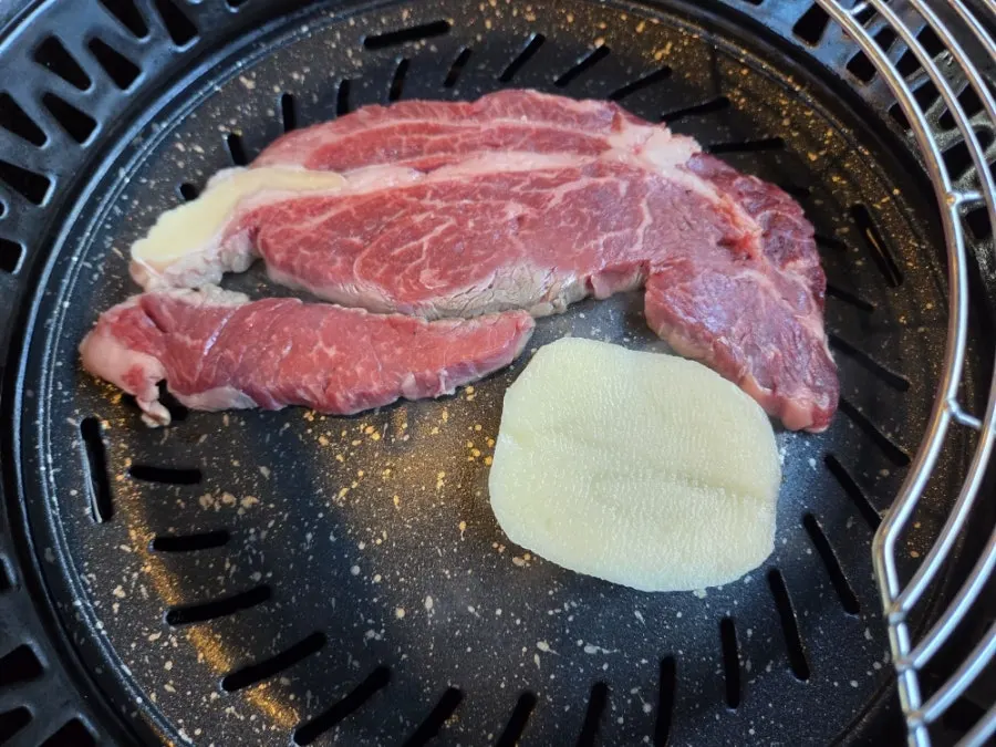 Sirloin and potatoes on the grill