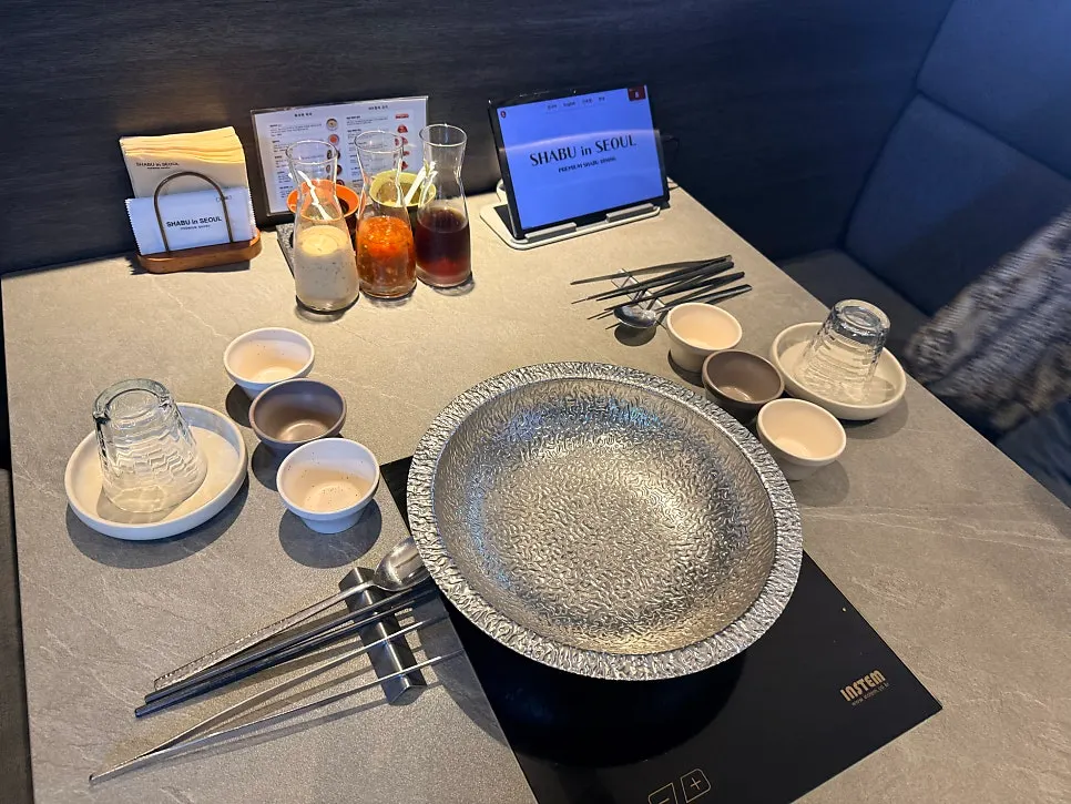 Sauce bottles and tongs on the table