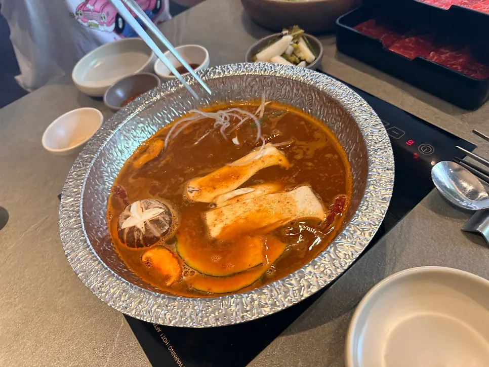 Spicy mushroom shabu broth starting to boil