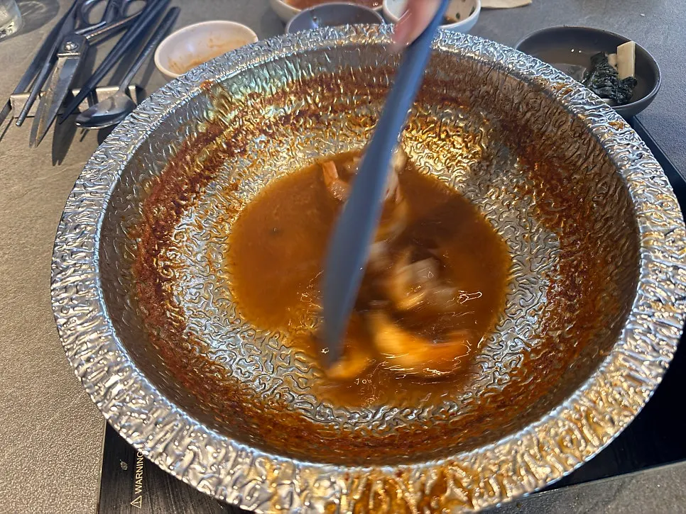 Rosé risotto being cooked with shrimp and mushrooms