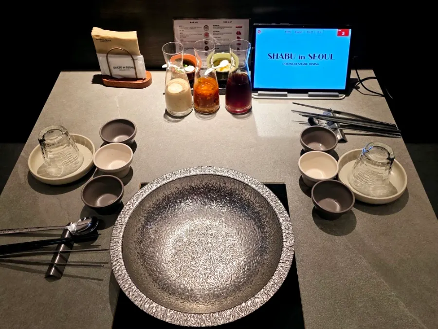 Table with shabu pot and tablet ordering