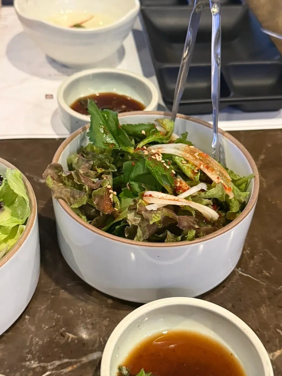 Salad with dressing and lettuce salad side