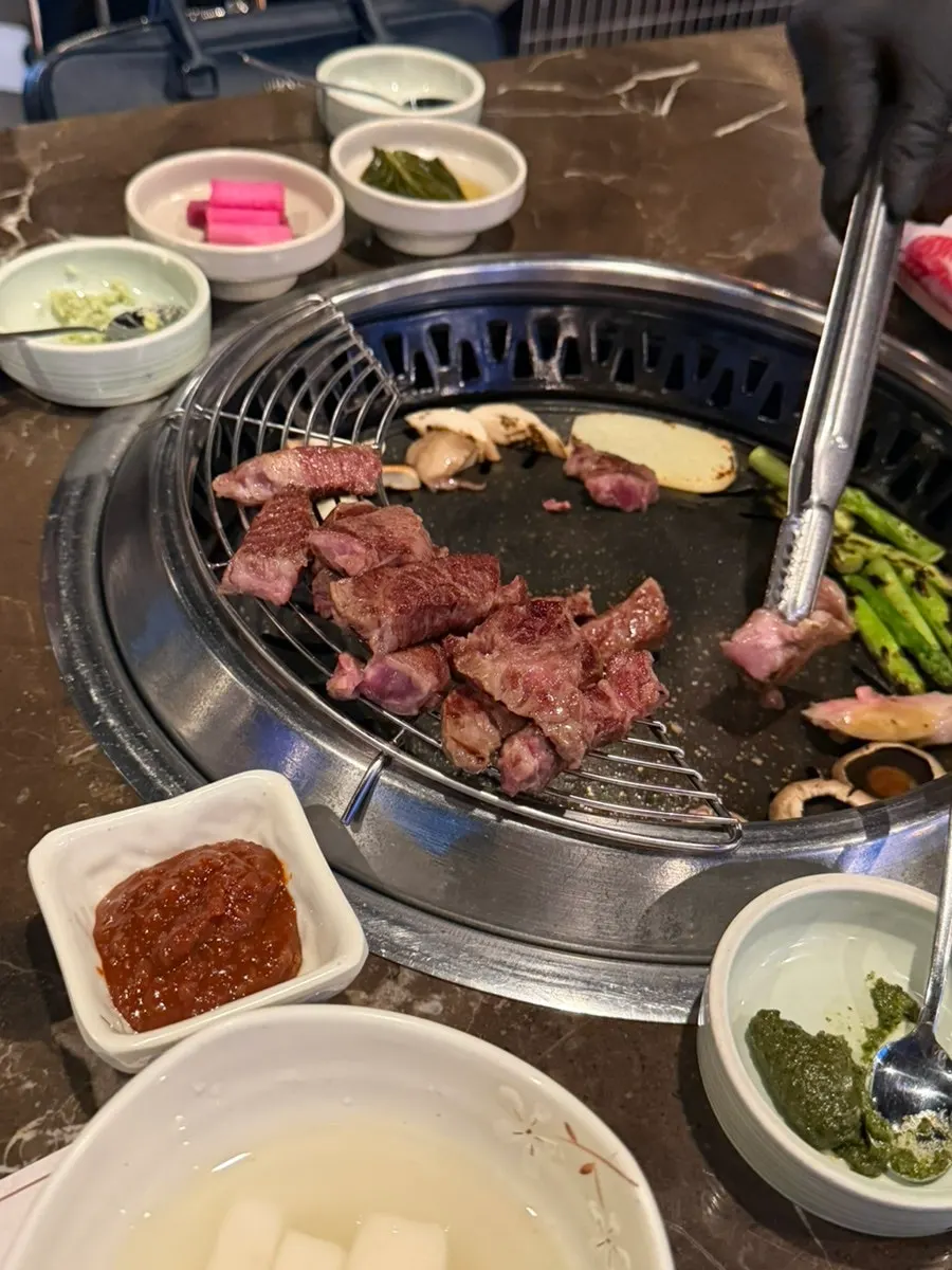 Grilled hanwoo set aside on top of the grill