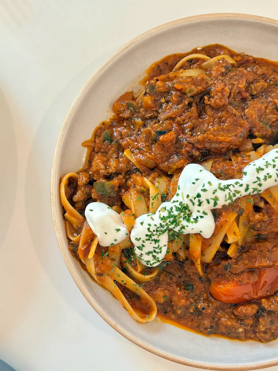 Spicy tomato ragu pasta with wide fettuccine noodles