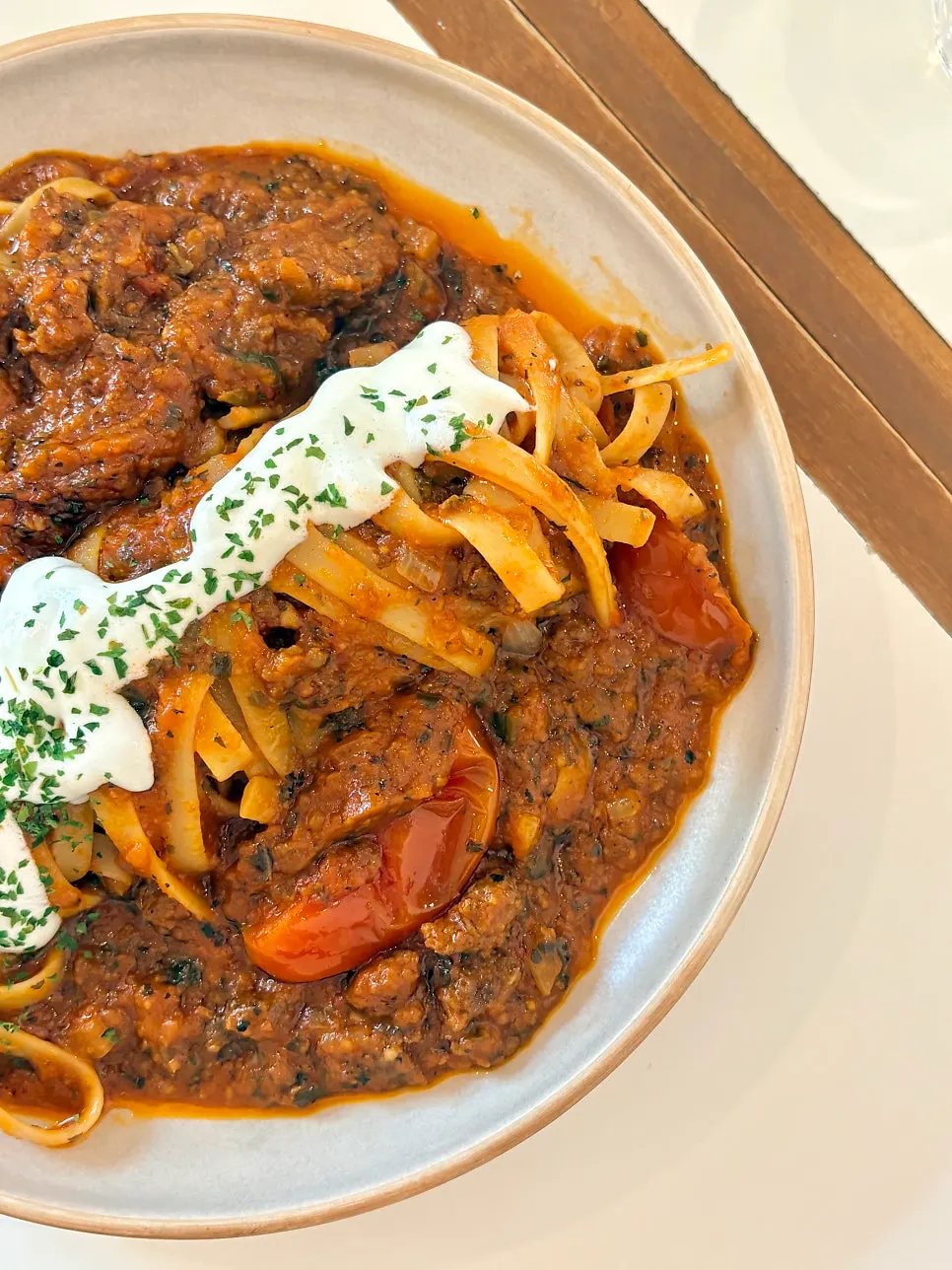 Ragu pasta topped with sour cream