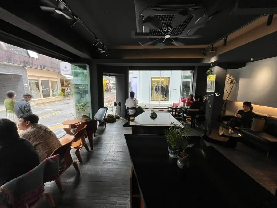 Interior of the café connected to the outside through the fully opened window