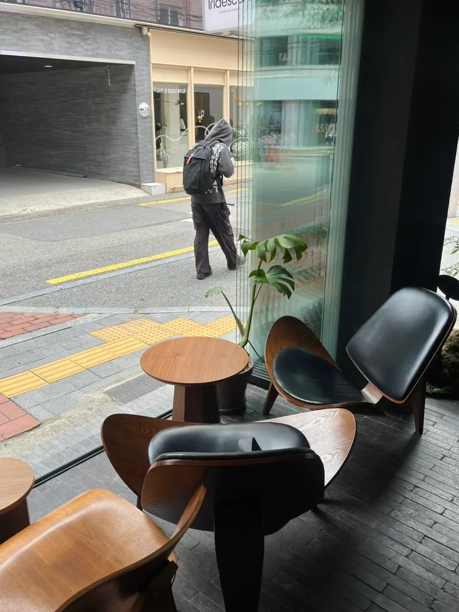 Open-concept café space with seating facing the floor-to-ceiling window