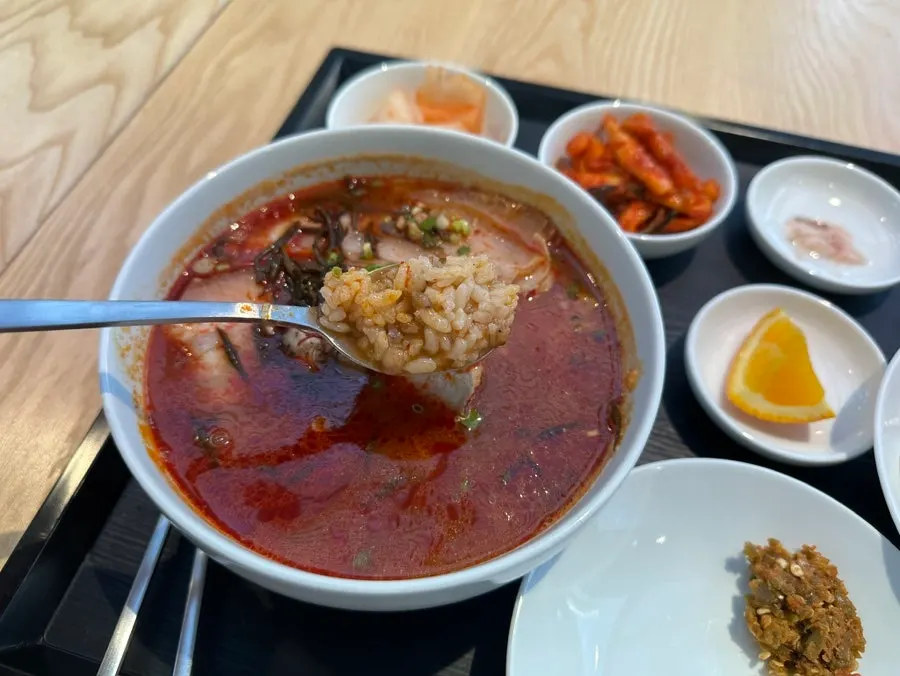 Spicy gomtang served with side dishes