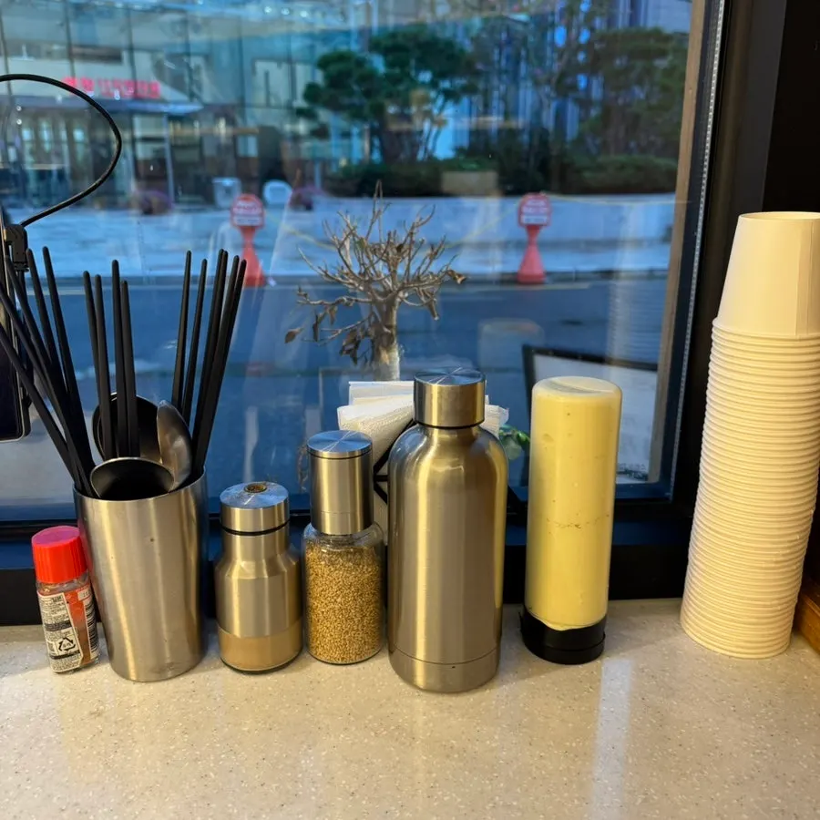 Sauce, salt, and dressing on the table