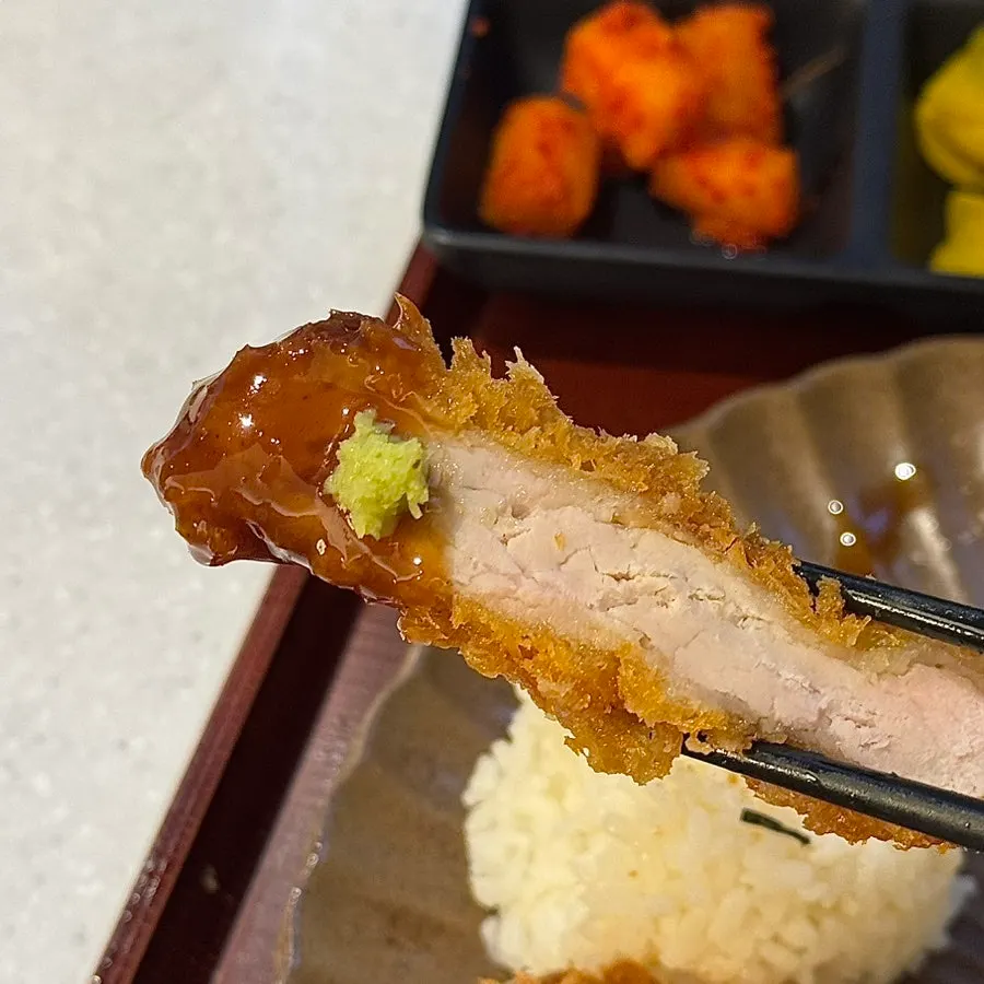 A piece of regular tonkatsu topped with wasabi