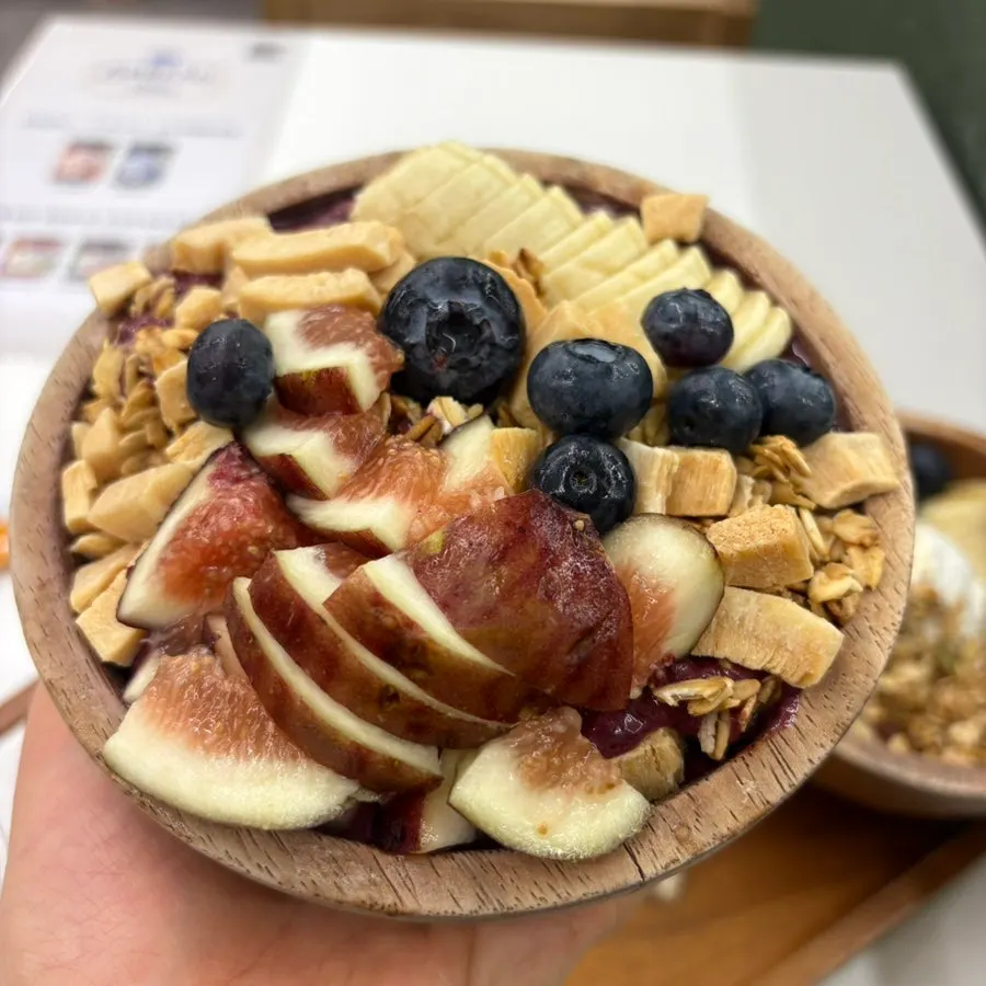 Acai bowl topped with coconut chips and oats