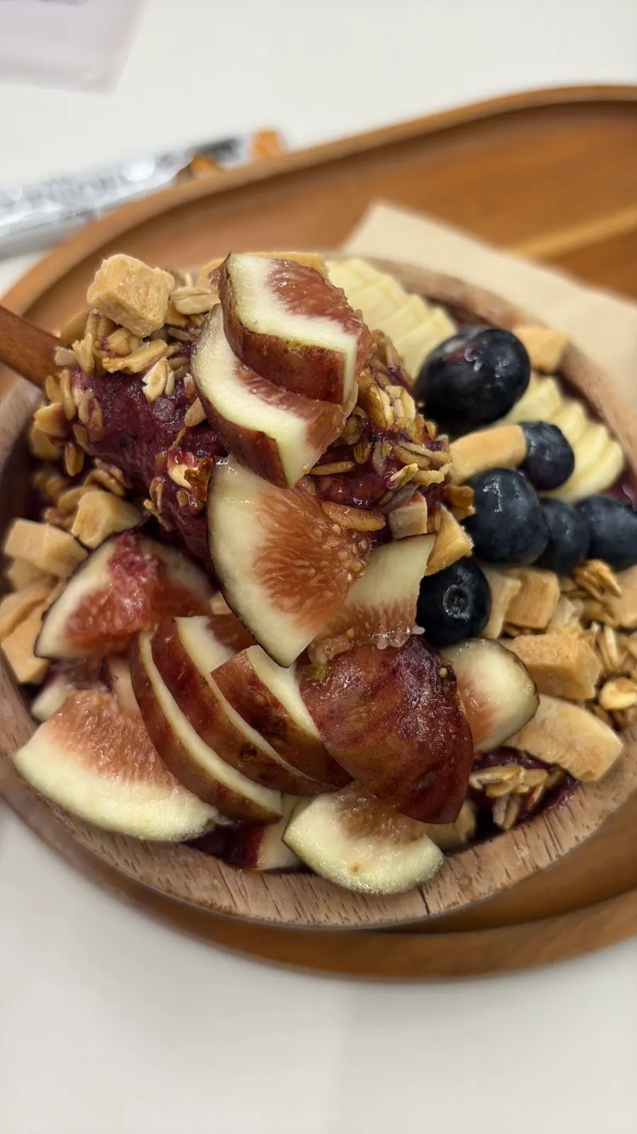 A spoonful of acai bowl with stick honey