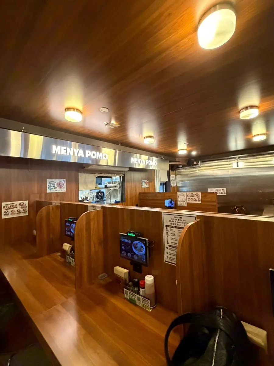 Interior of Menya Pomo Seongsu Branch decorated in wood tones