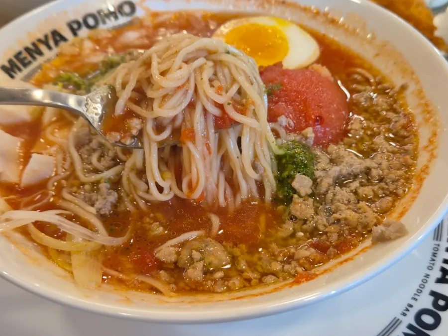 Chicken tomato ramen topped with chicken breast