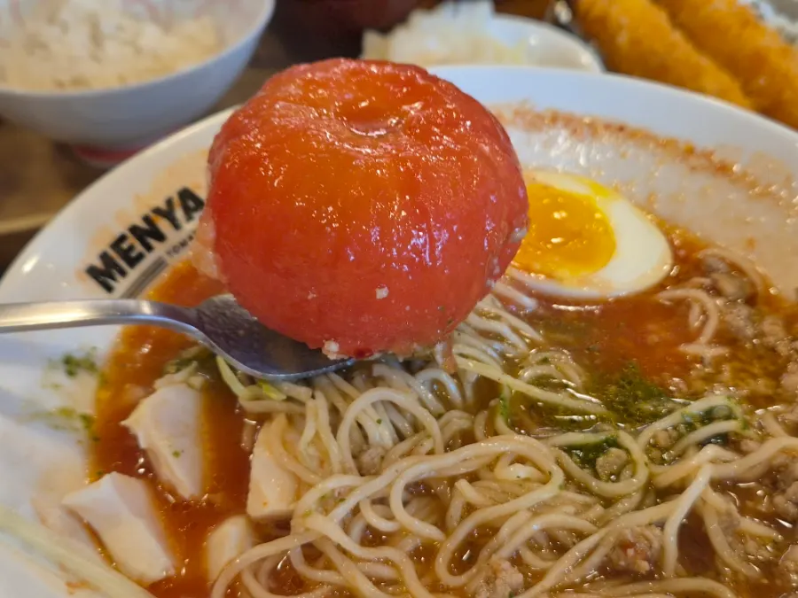Tomato ramen broth with onion and meat