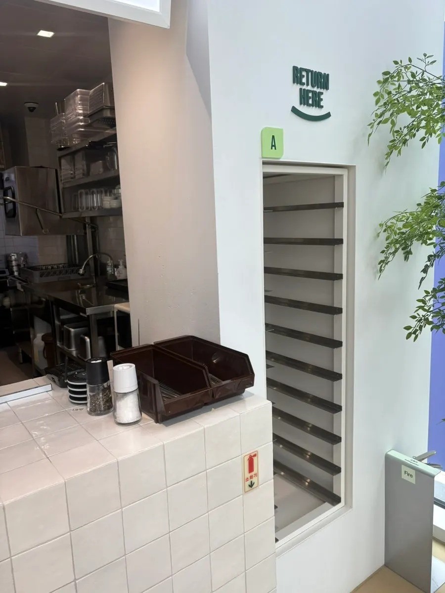 Dish return counter on the right side of the store