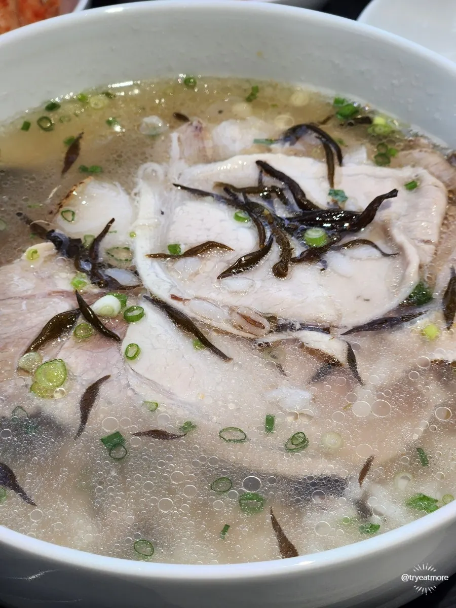 A bowl of clear pork gomtang topped with tot seaweed