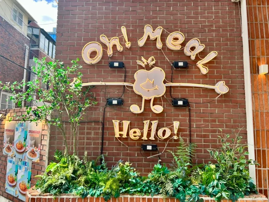 The Oh! Meal! sign and character