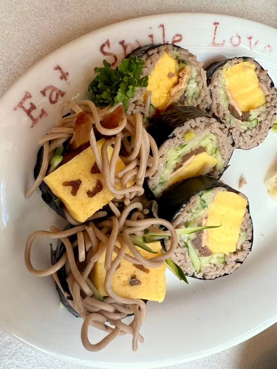 Close-up of the rolled egg with a face drawn on it
