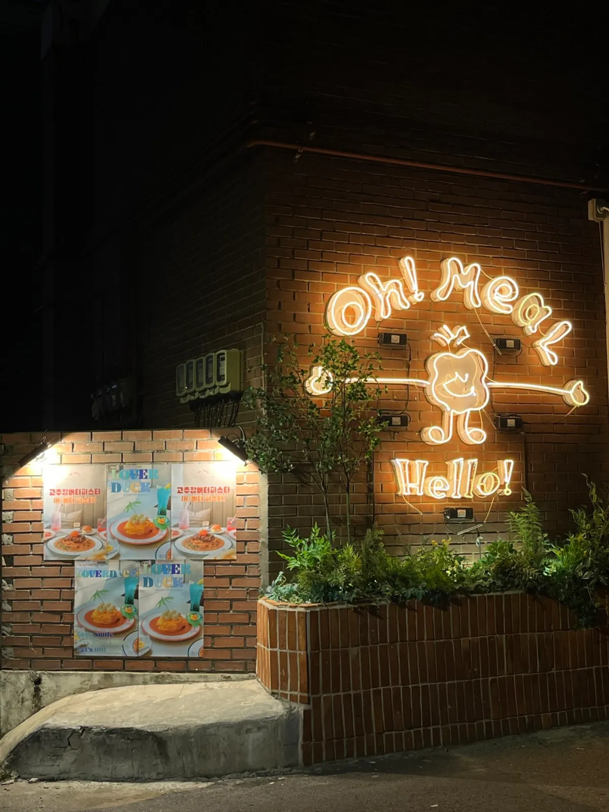 Brick exterior of Omil Seongsu with a menu poster on the wall