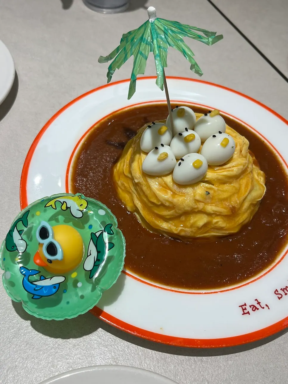 Rubber duck omurice topped with a parasol decoration and duck figurine
