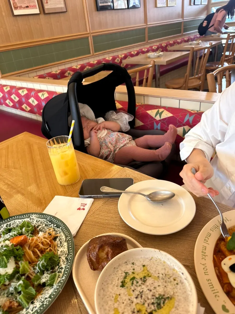 A laughing baby at the table during the meal