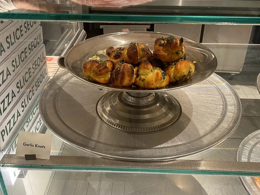 Evening display case of pizza varieties