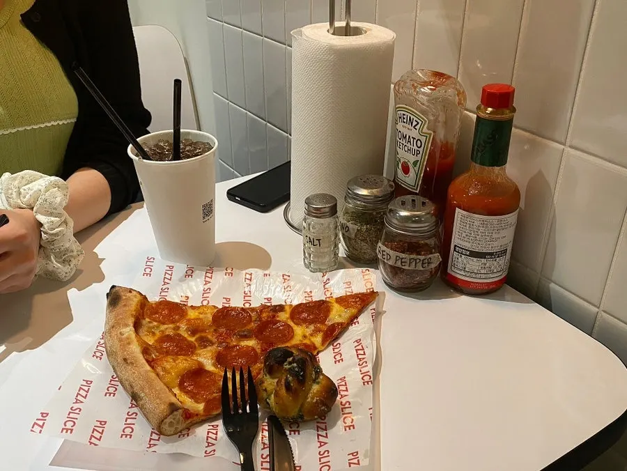 Pepperoni pizza sprinkled with crushed pepper