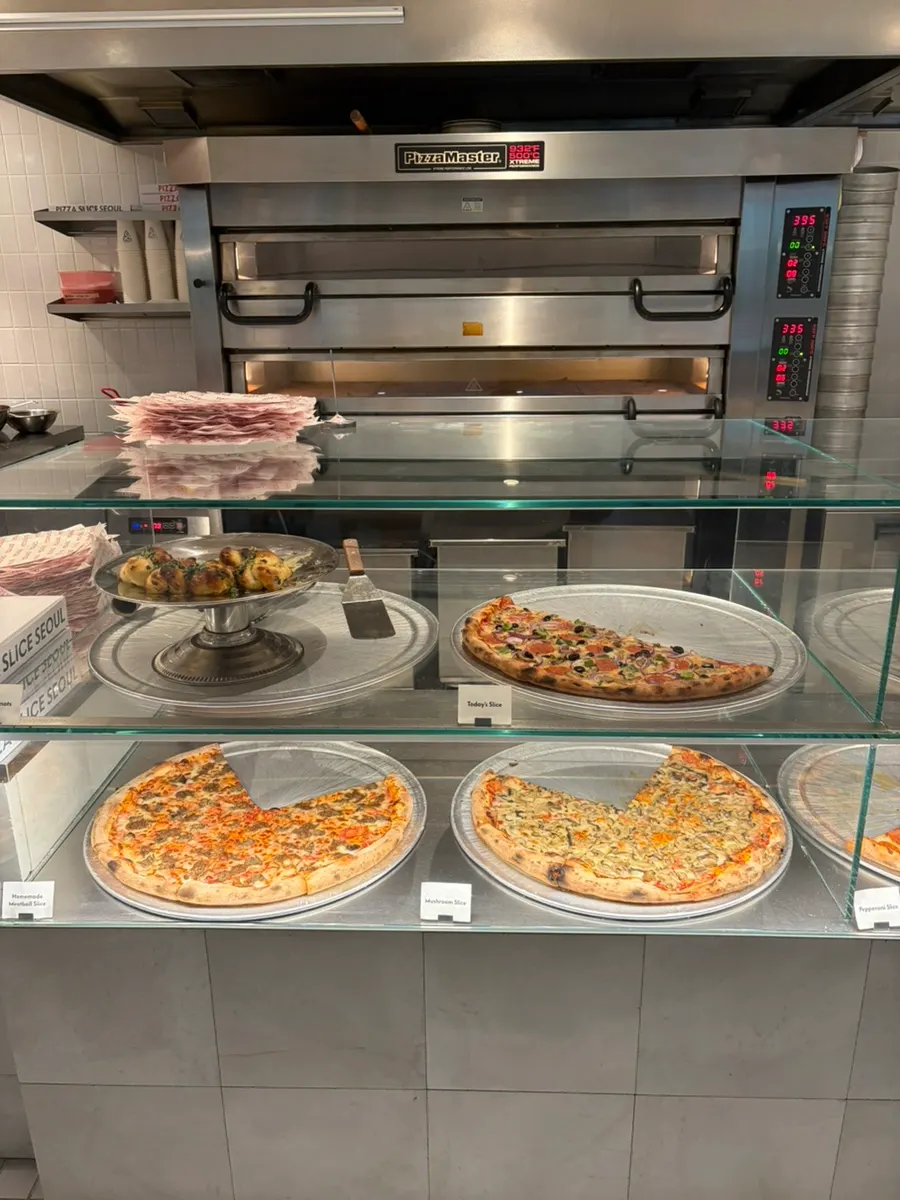 Display case of slice pizzas