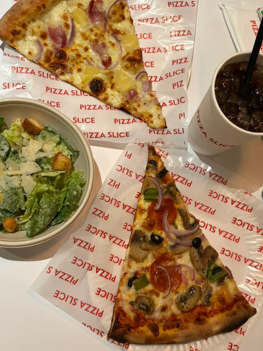A warm, freshly heated slice pizza