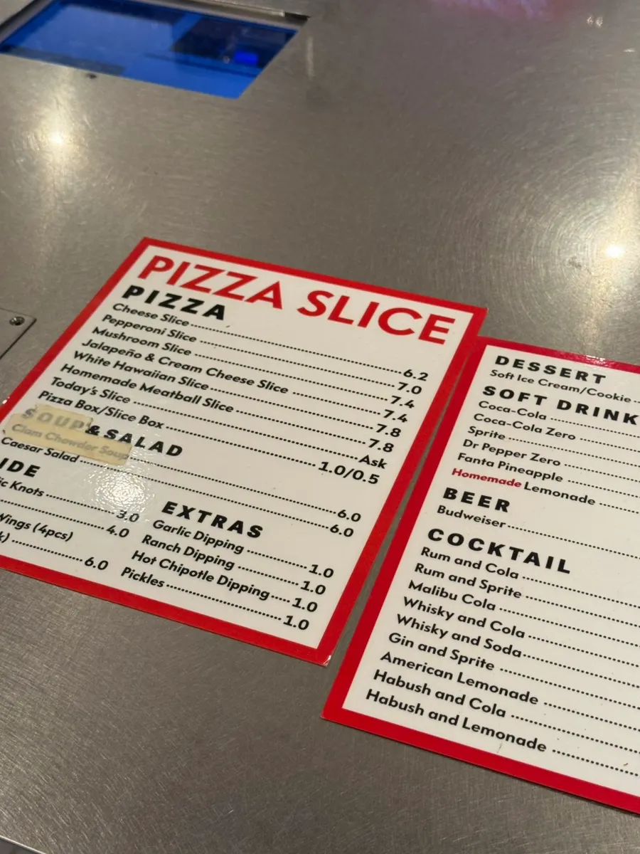 Menu board listing pizzas and sides