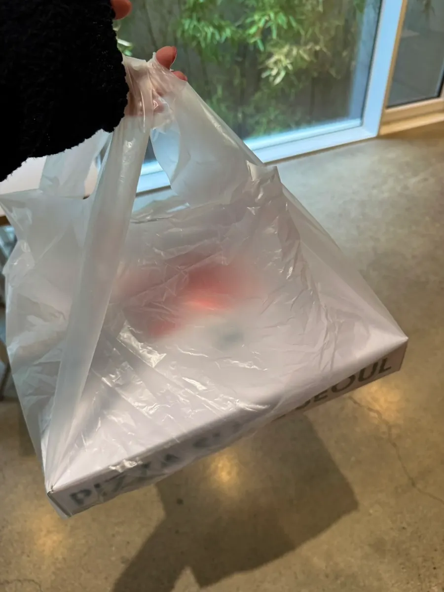 Four slices of pizza boxed up to take to Seoul Forest