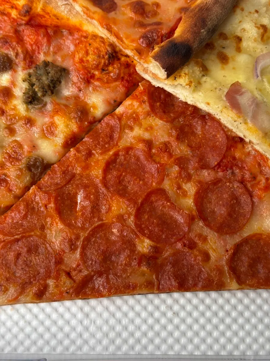 Thin-crust pepperoni slice packed with pepperoni