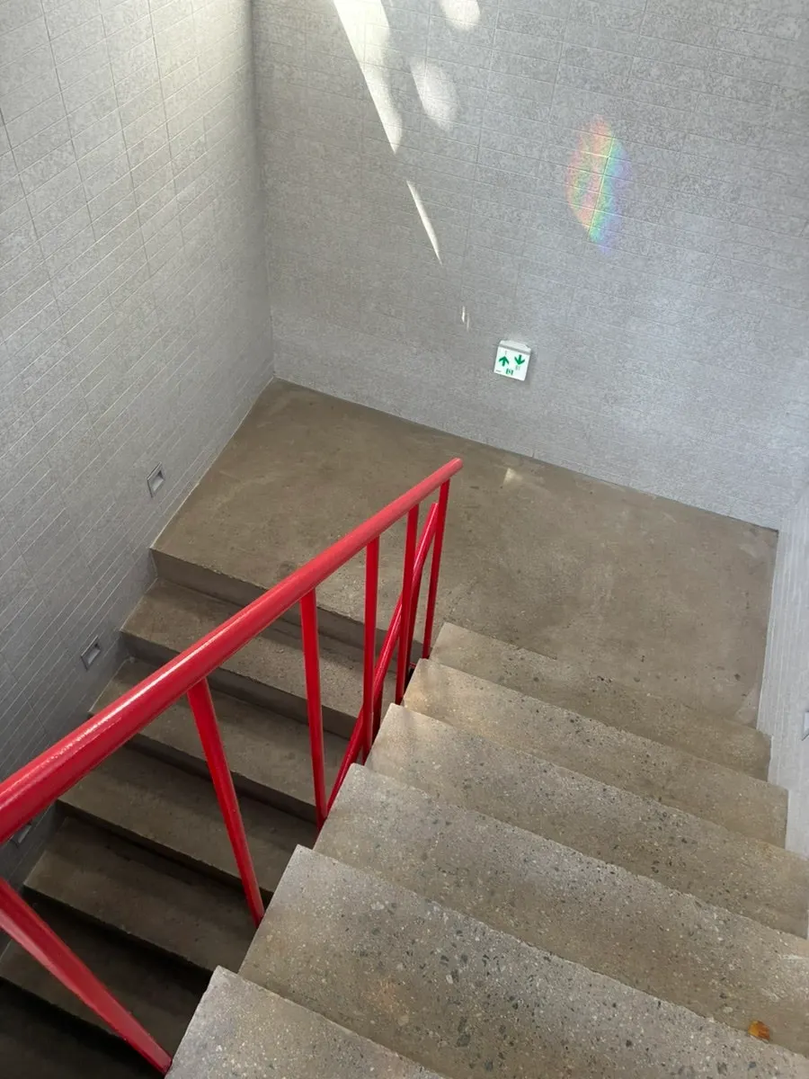 Stairs leading down to the basement pizza shop