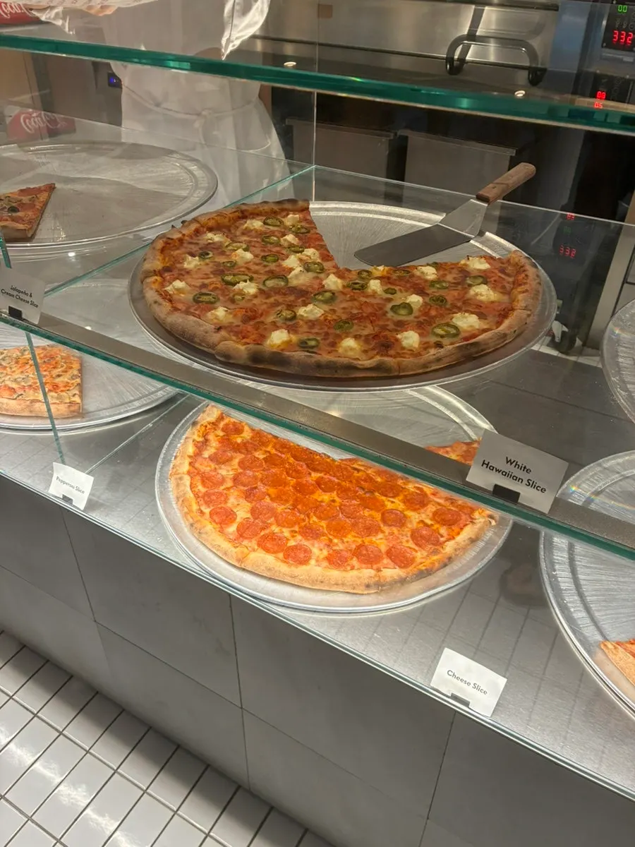 The open kitchen baking pizzas