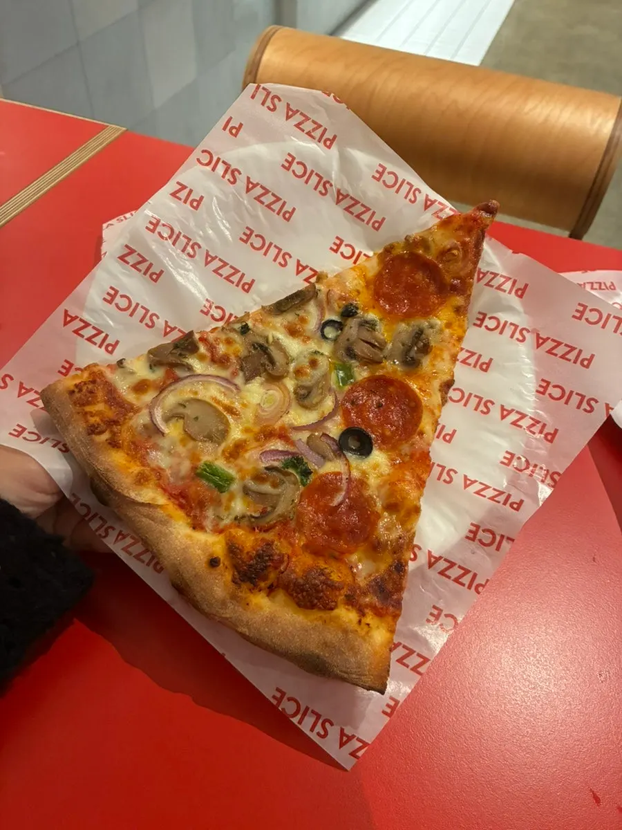 Three slices of pizza with buffalo wings