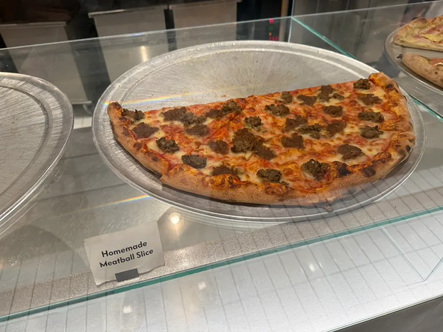 Pizza slices displayed in the showcase